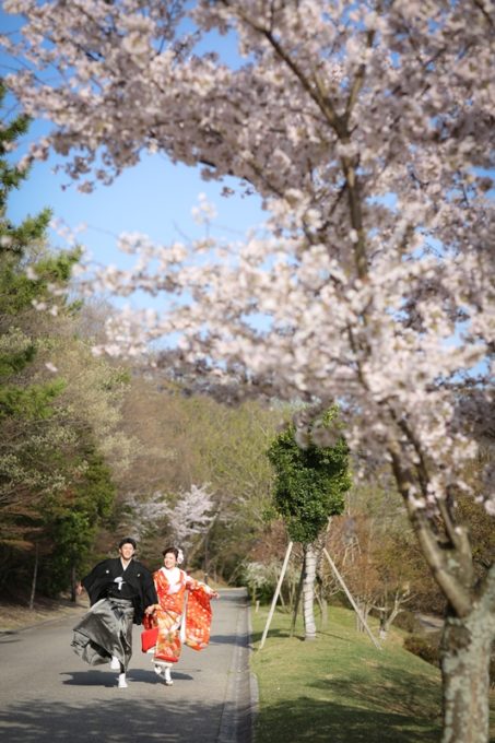 桜の木の下を走る夫婦